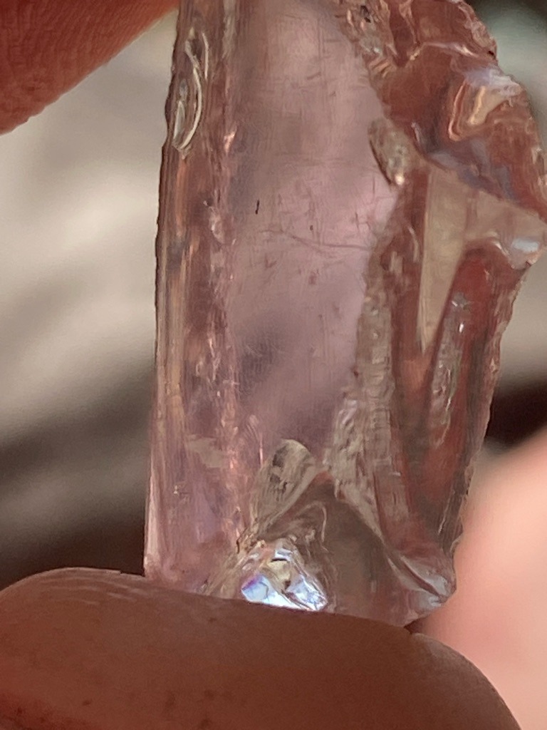 Rough natural crystal, though visual appearance strongly suggests a crystalline quartz, possibly rose quartz or a glass/slag simulant rather than a genuine diamond due to conchoidal fractures and lack of adamantine luster. - Rough uncut crystal/peice with irregular natural or fractured facets