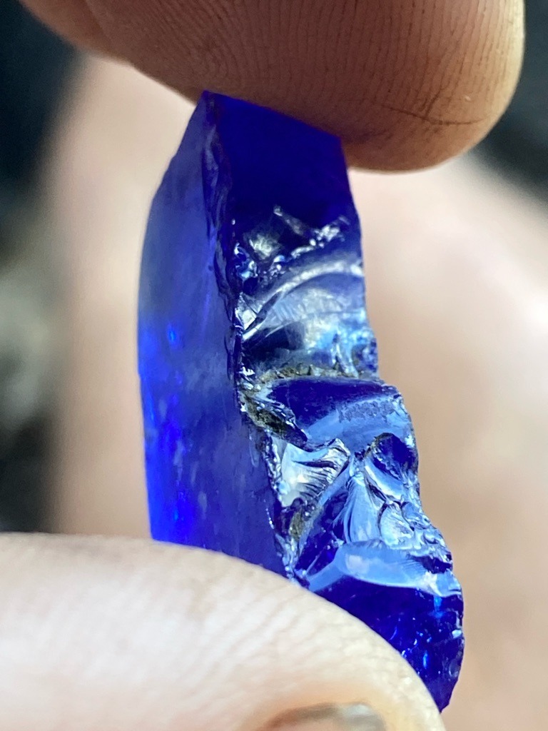Not a diamond; this is a piece of rough blue glass or synthetic material, displaying conchoidal fracture typical of amorphous substances. - Rough irregular fragment / unprocessed crystal form