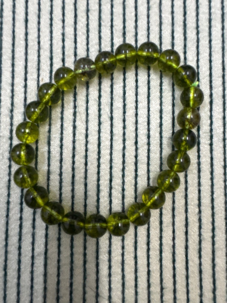 Not a diamond (appears to be a peridot or green tourmaline beaded bracelet) - Spherical bead