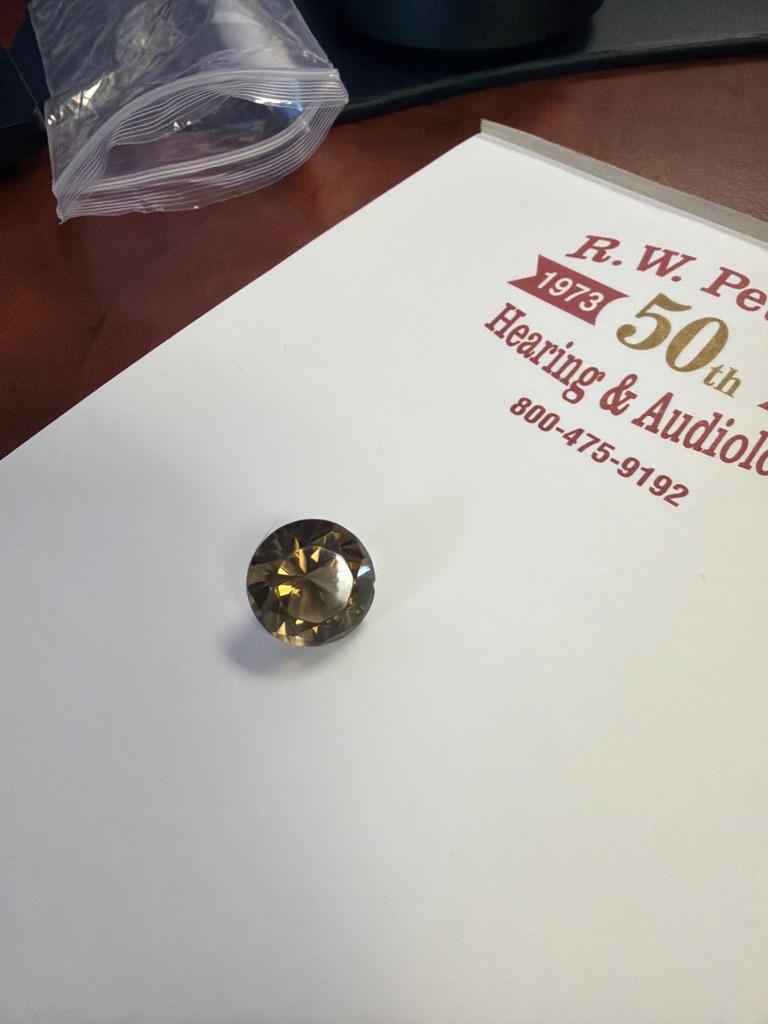 Smoky Quartz (Often misidentified or used as a diamond simulant in costume jewelry; visually exhibits brown coloration atypical of traditional diamonds, though brown 'champagne' diamonds exist naturally) - Round Brilliant