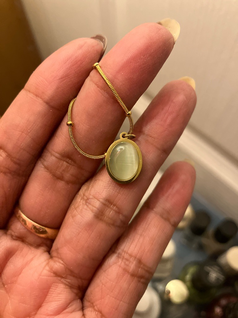 The gemstone pictured is not a diamond. It is a Chrysoberyl Cat's Eye or a simulated chatoyant gemstone (like glass fiber optic). - Oval Cabochon