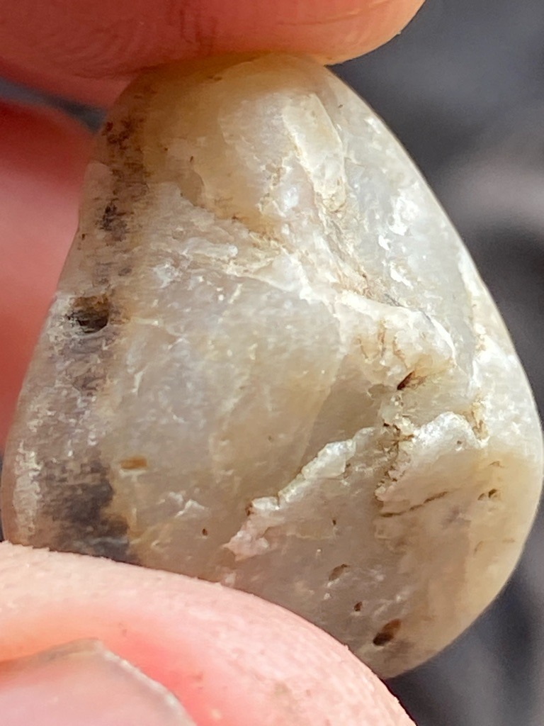 Not a diamond (appears to be a water-worn pebble, possibly quartz, quartzite, or chalcedony) - Irregular / Rough Pebble