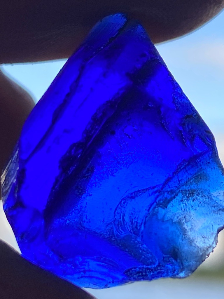 Not a diamond; this is a piece of cobalt blue colored glass or slag glass, exhibiting characteristic conchoidal fracture patterns. - Raw, unpolished, irregularly shaped rough fragment (not a standard faceted diamond cut).