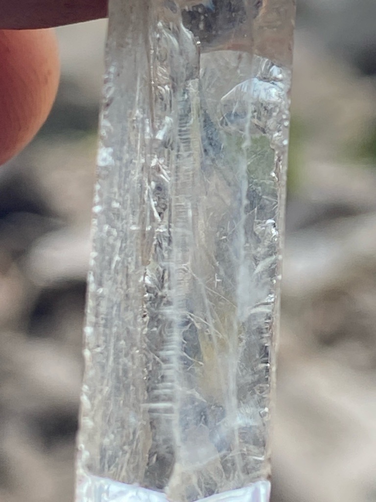 Not a diamond; this is a raw, unpolished quartz crystal showing typical striations and natural growth features. - Raw crystal / Untouched rough mineral specimen