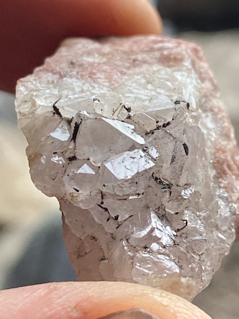 Natural rough mineral matrix, likely quartz or feldspar with embedded crystal structures rather than a cut diamond specimen. - Uncut, natural crystal habit showing octahedral or modified crystal faces embedded in matrix.
