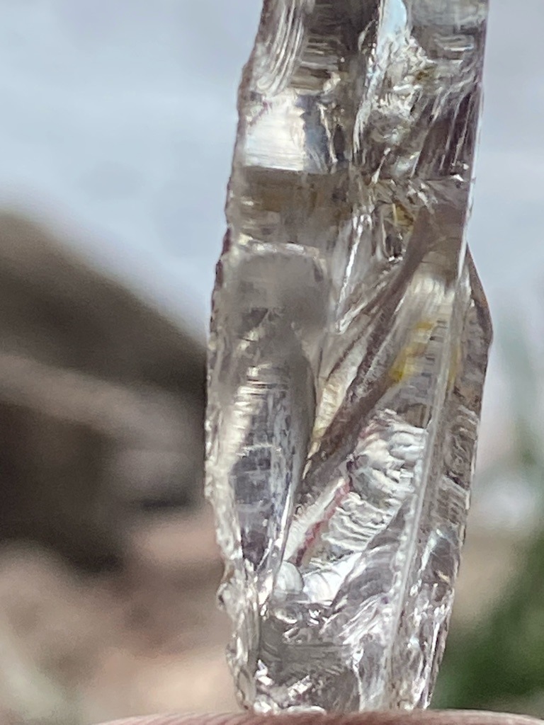 Natural rough diamond crystal with characteristic growth striations and natural surface features. - Uncut rough elongated crystal form, somewhat irregular tabular or elongated shape.