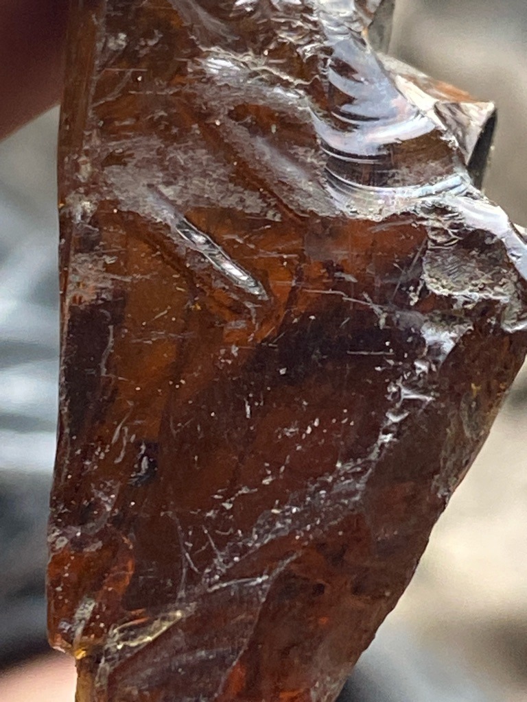 Not a diamond; appears to be industrial slag glass or amber due to conchoidal fracturing and vitreous luster. - Rough / Raw Uncut Piece with Conchoidal Fracture