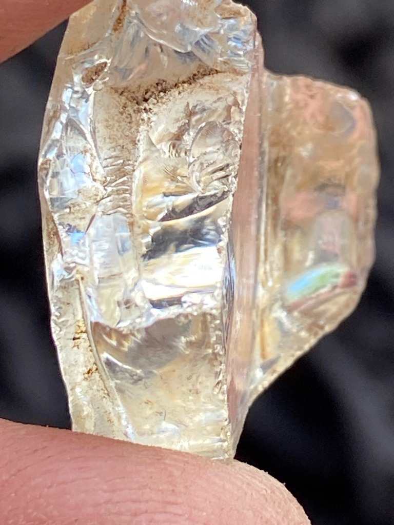 Not a diamond; appears to be raw quartz, glass slag, or another mineral specimen based on conchoidal fracturing and inclusions. - Raw, uncut, or heavily fractured crystalline specimen.