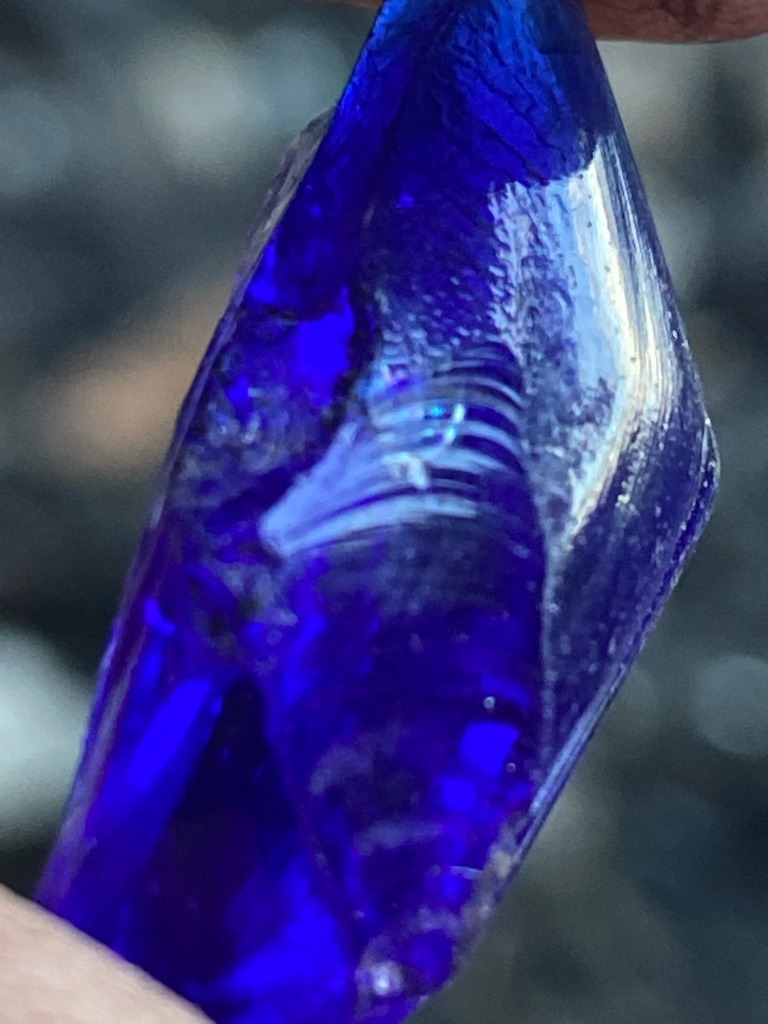 Not a diamond; this is a piece of blue glass showing typical conchoidal fracture and flow lines. - Irregular rough / raw shard