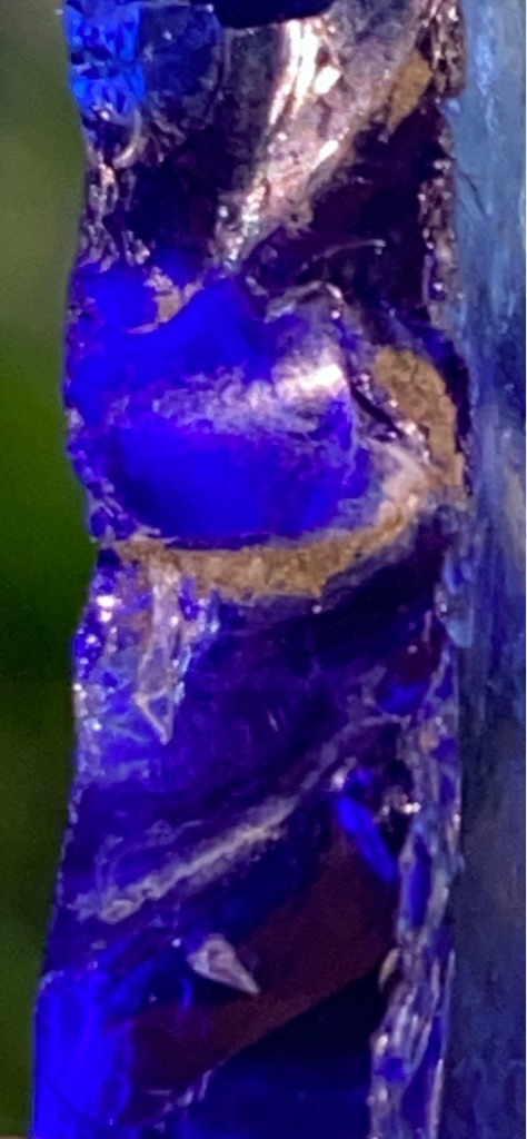 Not a diamond; this specimen appears to be rough mineral matter or synthetic glass with strong fluorescence under UV light, lacking the distinct crystal structure and optical properties of diamond. - Rough uncut crystal / irregular fragment, non-standard shape.