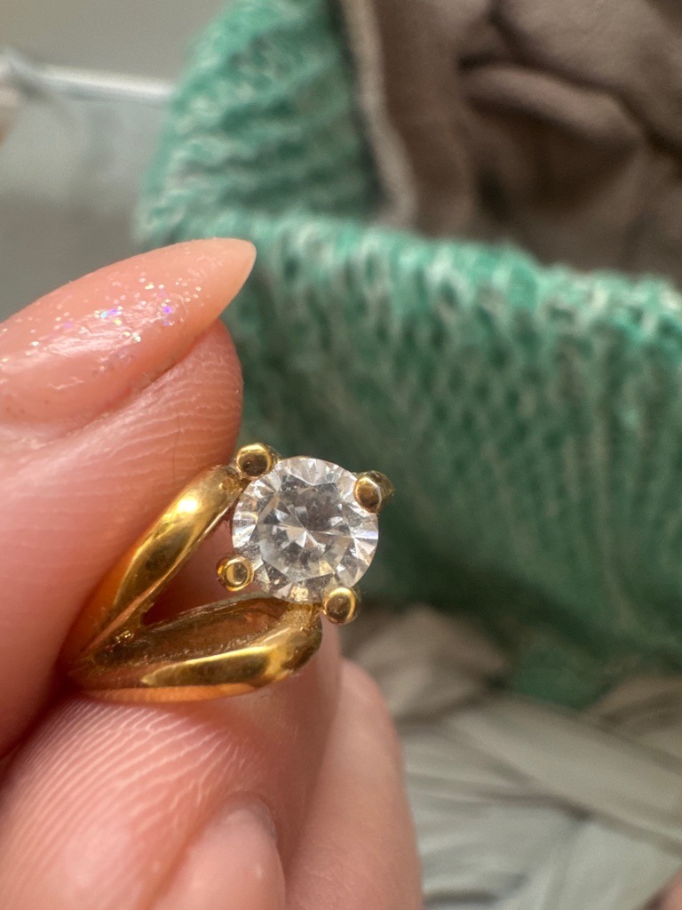 Likely Natural Diamond or Simulant (Simulants like CZ are common in this style of costume setting) - Round Brilliant