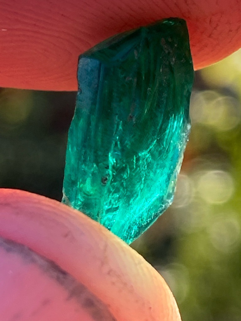 Not a diamond; this specimen is a rough emerald or green beryl crystal. - Raw, un-faceted columnar crystal with natural termination.