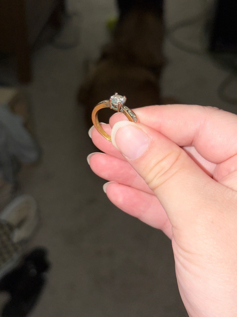 Natural Diamond (likely, based on ring style) - Round Brilliant
