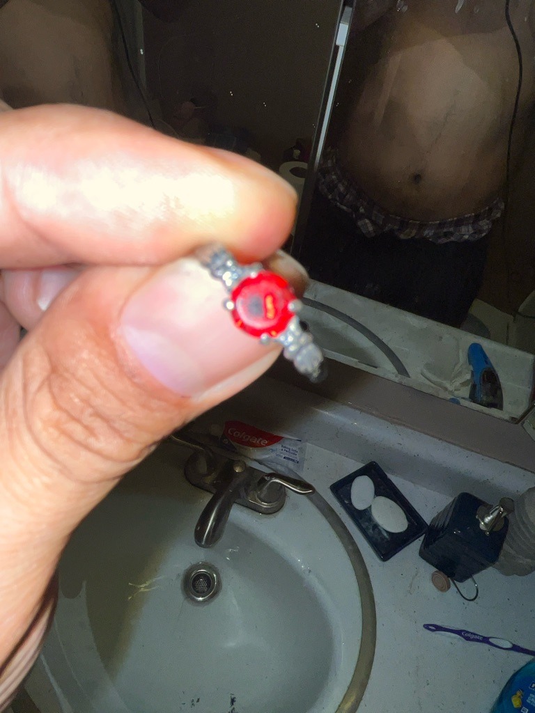 Not a diamond; appears to be a red glass or synthetic gemstone toy ring - Round