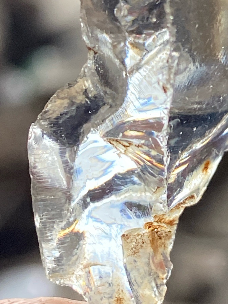 Rough natural crystal specimen (showing conchoidal fracture lines and striations characteristic of crystalline quartz or rough diamond, though visually strongly indicative of untreated natural rough mineral crystal) - Rough uncut crystal / Untreated raw form