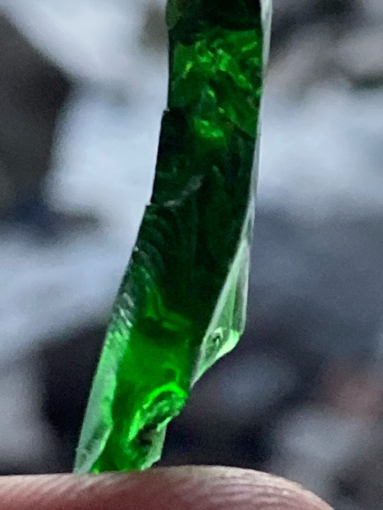 Not a diamond; this specimen appears to be green glass or synthetic glass slag, lacking the crystalline structure, hardness, and optical properties of a true diamond. - Rough uncut shard / irregular fragment