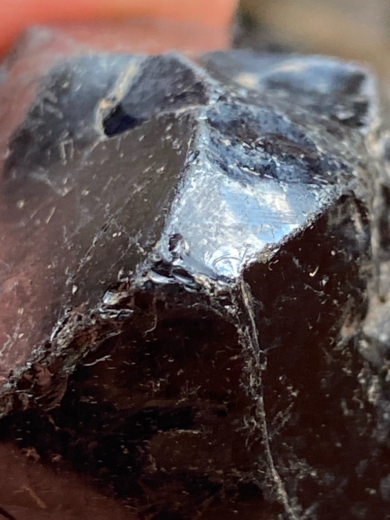 Not a diamond; appears to be industrial carbonado (black diamond rough) or slag/obsidian material based on the vitreous luster and fracture pattern - Rough / Uncut crystal fragment