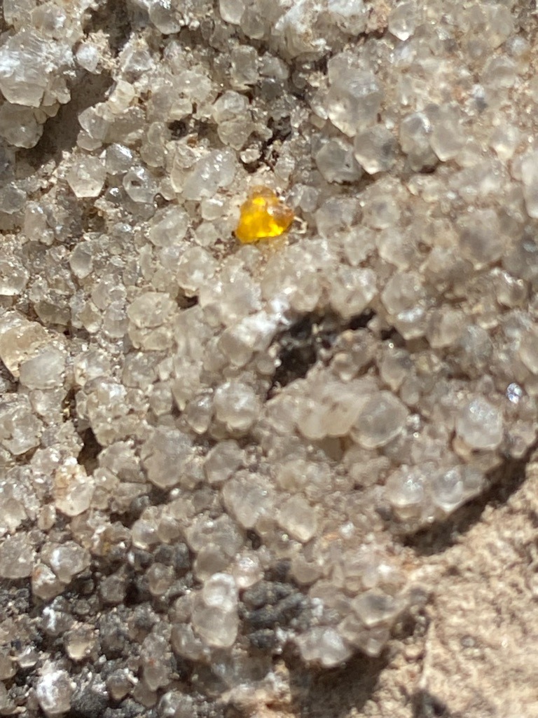 Natural rough crystal cluster, potentially quartz or similar mineral matrix with a distinct amber-colored inclusion or crystal fragment - Raw, unpolished crystal cluster / granular aggregate