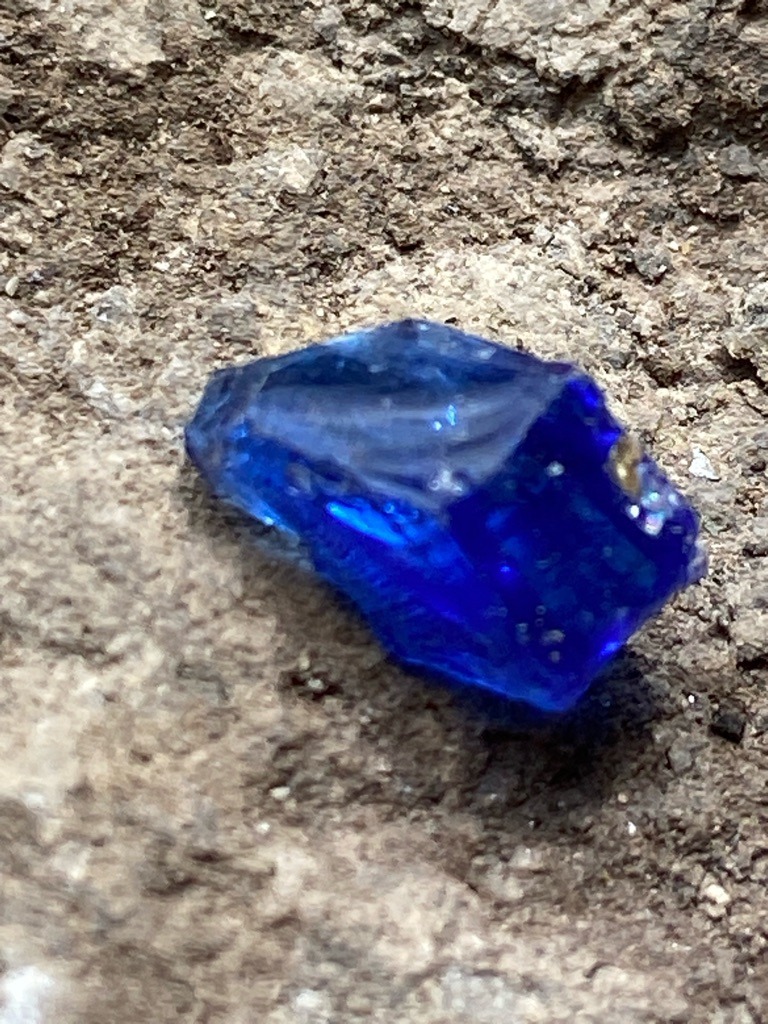 Not a diamond; this specimen is a rough piece of blue glass or synthetic cobalt-doped material, displaying conchoidal fracture and internal gas bubbles characteristic of glass rather than any natural gemstone or diamond. - Rough, irregular, un-faceted raw nugget or cullet.