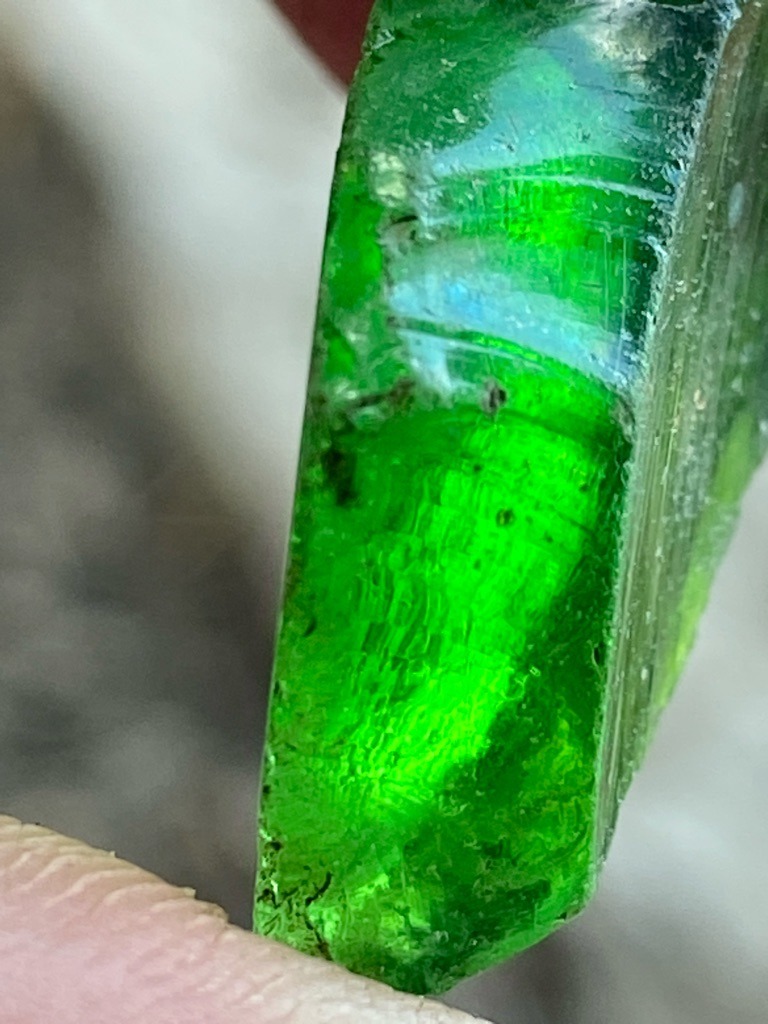 Not a diamond; this is a rough green mineral specimen, likely colored glass, synthetic quartz, or a beryl variant such as emerald, showing characteristic conchoidal fracture and surface striations. - Rough crystal / Uncut specimen with elongated prismatic habit