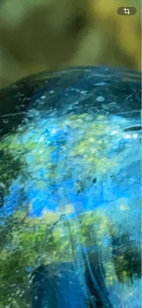 Not a diamond; the image displays a gemstone with labradorescence, strongly resembling Labradorite or a similar feldspar mineral, not a crystalline diamond. - Cabochon / Irregular polished surface