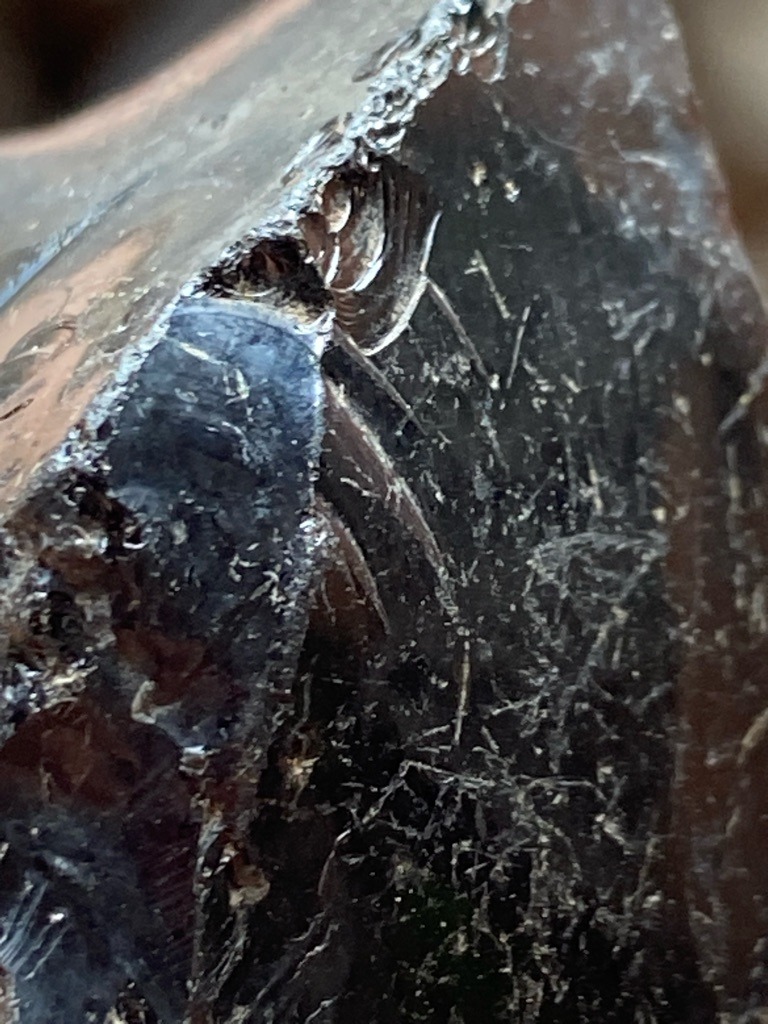 Not a diamond; appears to be industrial or raw mineral material showing conchoidal fracture (likely obsidian, slag, or rough dark mineral) - Rough uncut / amorphous mass