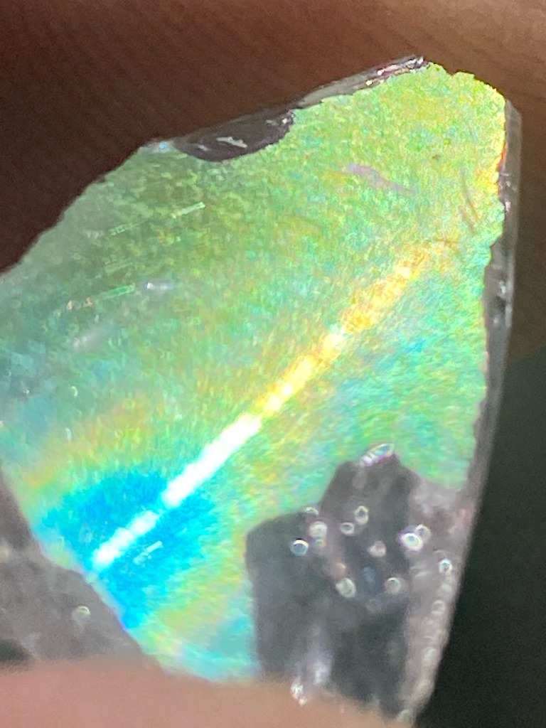Not a diamond (appears to be a coated or iridescent specimen, possibly optical glass or resin) - Irregular raw fragment
