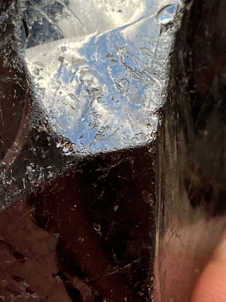 Not a gemstone; appears to be industrial slag or a rough mineral fragment with reflective crystalline matrix. - Irregular / Raw Fragment