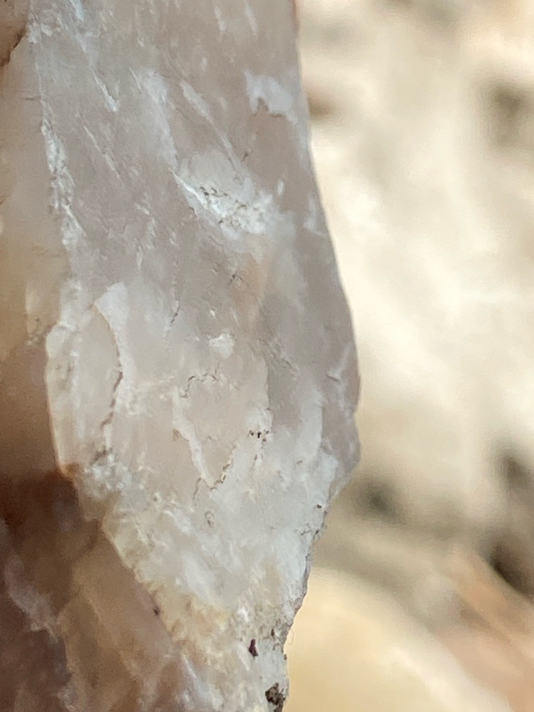 The provided image displays a rough, unprocessed crystalline mineral specimen, likely quartz or a similar pegmatite host rock, rather than a polished diamond gemstone. - Irregular rough crystal form, unpolished and uncut