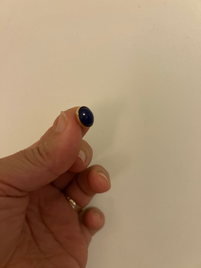 Not a diamond; this item appears to be a cabochon-cut colored gemstone, likely lapis lazuli or blue sapphire, set in a gold bezel mount. - Oval Cabochon