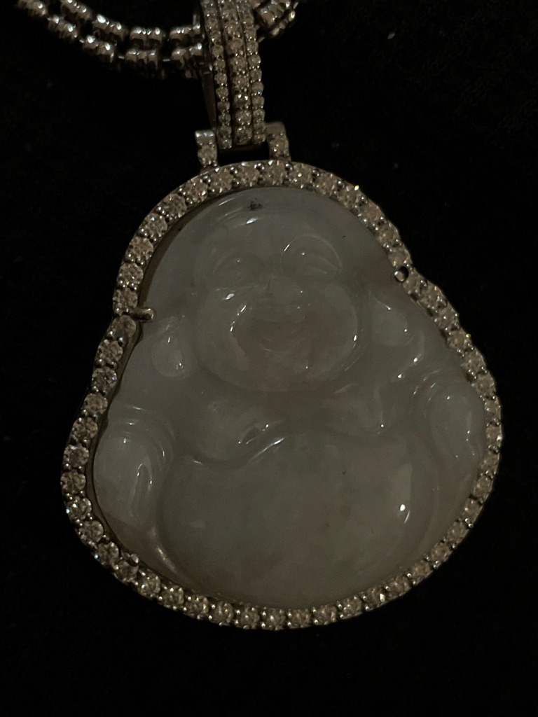 Natural (for the accent diamonds) and a central carved White Jadeite stone - Round Brilliant (accent diamonds) and Carved Buddha (central gemstone)