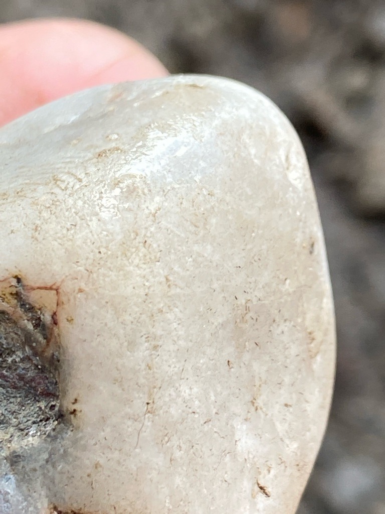 Not a diamond; this is a rough, unworked alluvial quartz or quartzite pebble/stone showing natural weathering, matrix attachments, and no crystalline diamond morphology. - Irregular, water-worn pebble or rounded nodule form