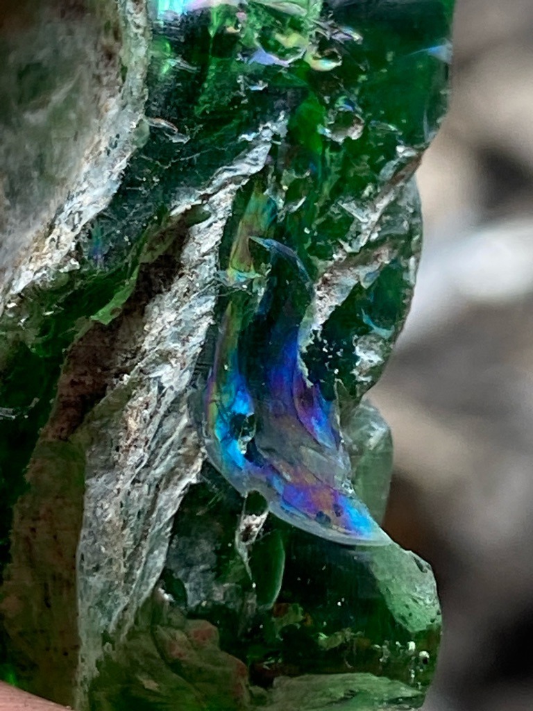 Not a diamond (appears to be rough glass slag or mineral with a coated/iridescent film) - Raw, uncut, amorphous mass