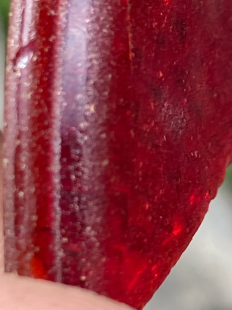 Not a diamond; visual characteristics indicate a translucent to opaque deep red material, possibly a cabochon-cut gemstone such as ruby, garnet, red glass, or resin aggregate, lacking standard diamond crystal structure. - Irregular freeform or cabochon fragment