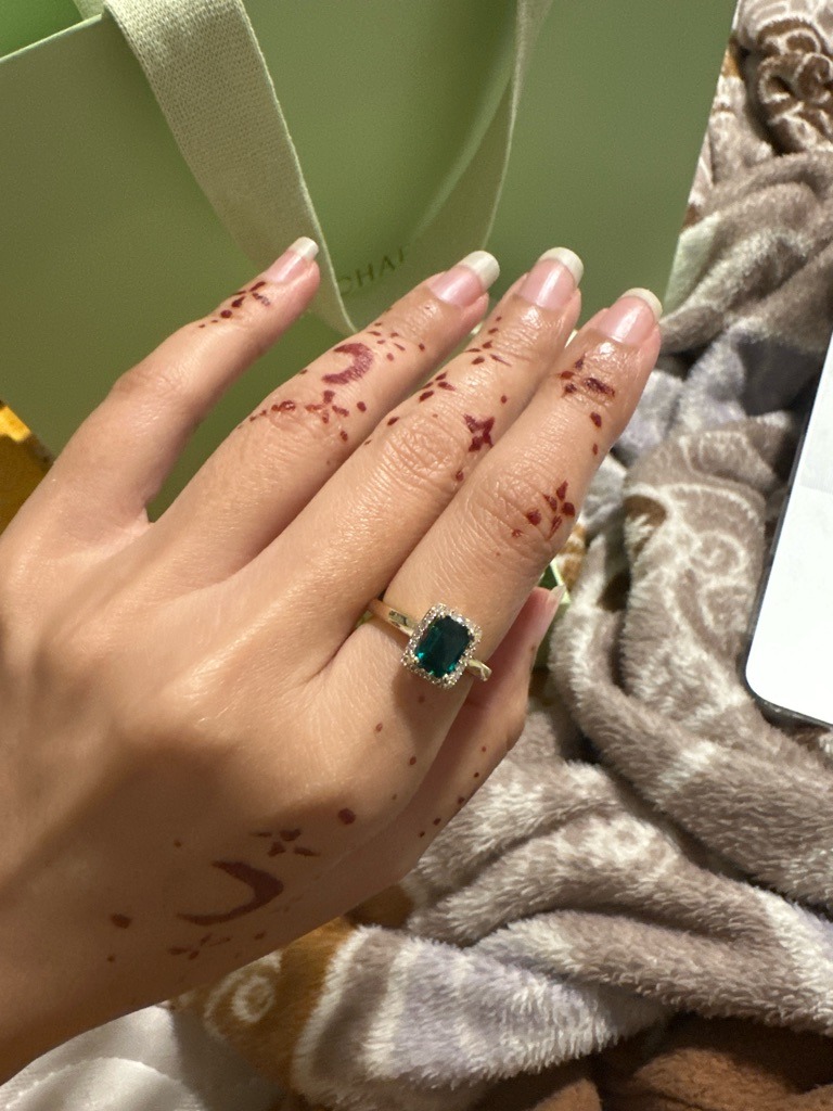 Likely Treated Natural or Lab-Grown Fancy Dark Green Diamond (Center Stone); White Diamond melee (Halo) - Radiant or Emerald Cut