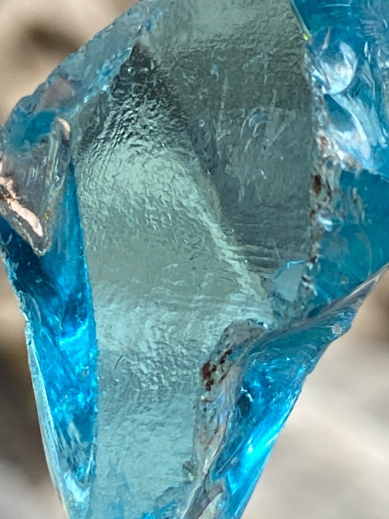 Not a diamond; appears to be colored glass or slag glass, or potentially an artificially colored quartz/mineral specimen. - Rough / Raw Uncut Specimen