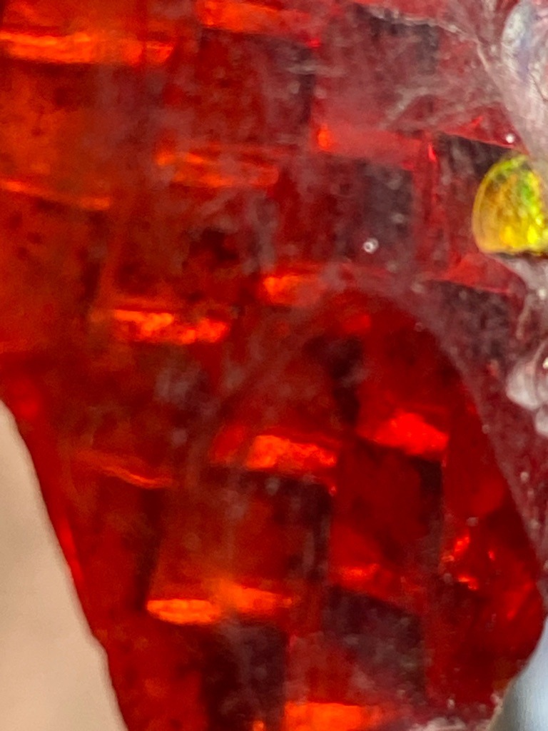 Not a diamond; this is a fire opal showing characteristic play-of-color with red and orange hues. - Irregular / Freeform cabochon or rough specimen