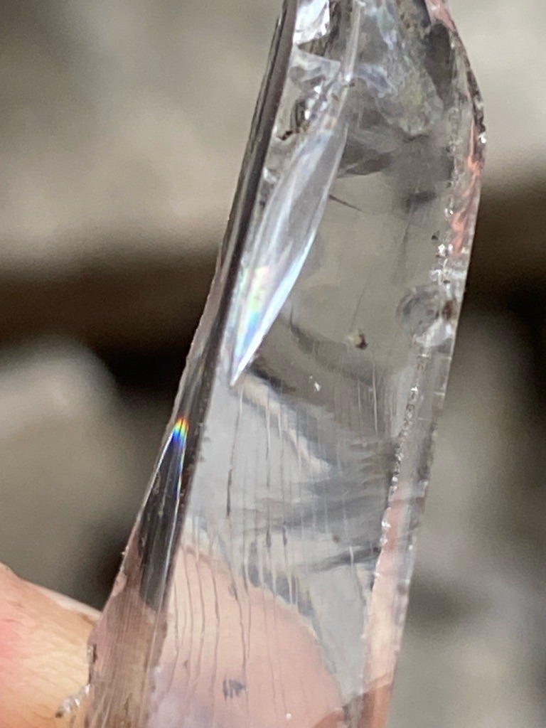 Not a diamond; this specimen appears to be a natural quartz crystal (rock crystal), showing typical prismatic growth habits and surface striations. - Rough crystal / Uncut natural mineral formation with prismatic habit