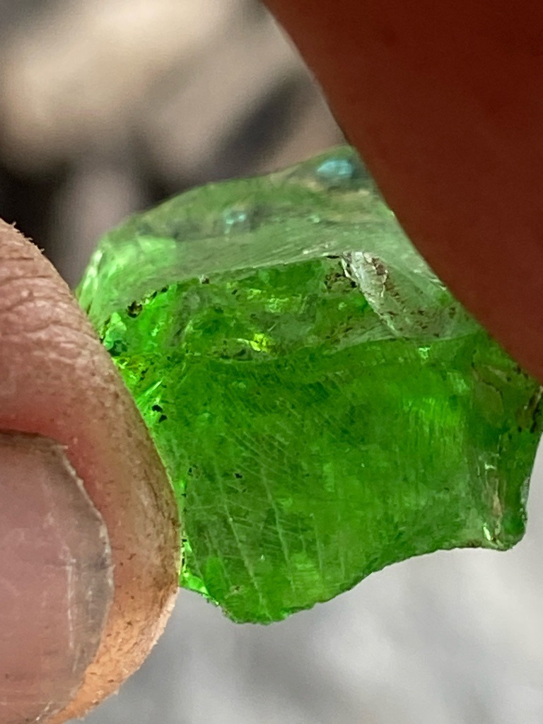 Not a diamond; this is a rough green gemstone, likely glass or a green mineral such as tourmaline or tsavorite garnet, but definitively not carbon-based diamond. - Rough uncut crystal / irregular chunk