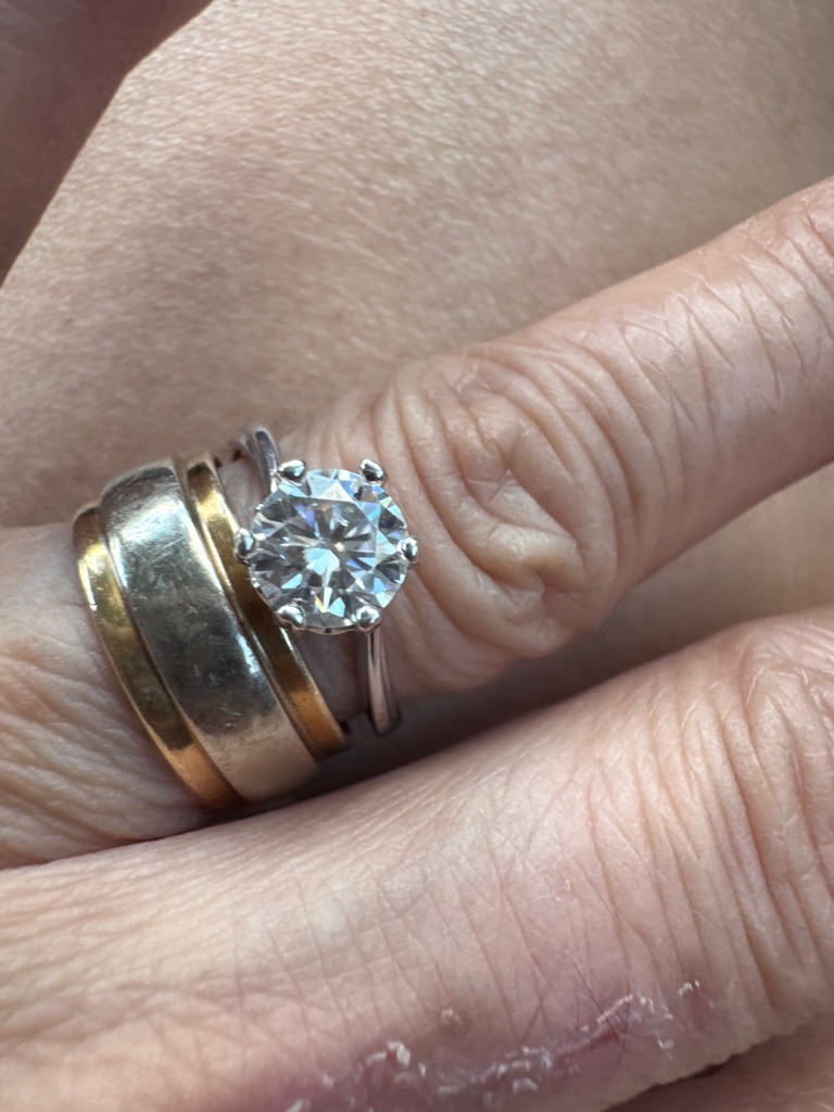 Natural Diamond (based on standard optical characteristics, though lab-grown cannot be entirely ruled out without spectroscopic testing) - Round Brilliant