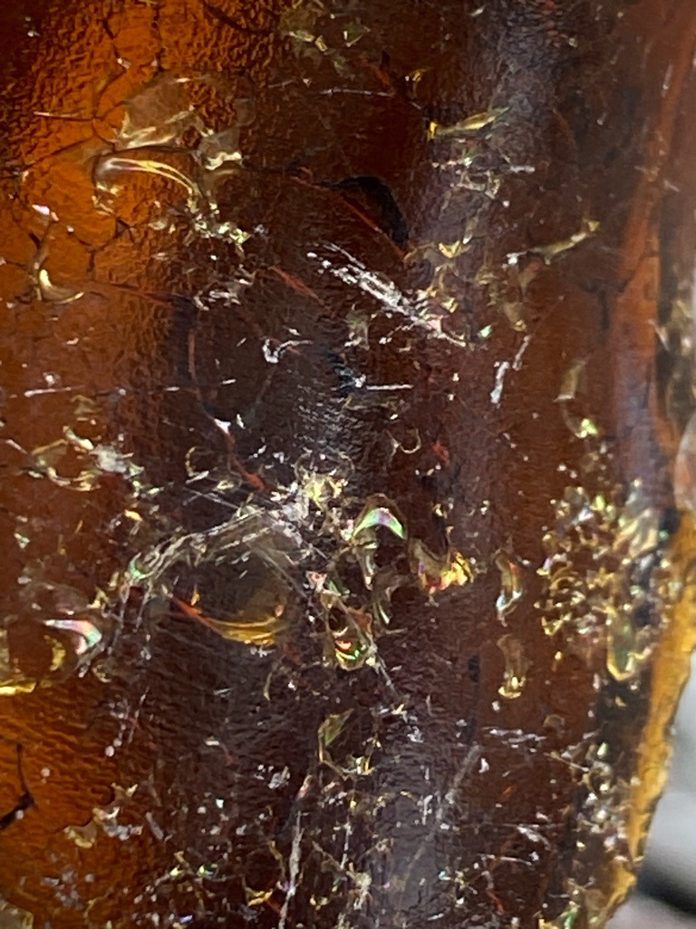 Not a diamond; the image shows amber or resin with internal stress fractures and inclusions, likely amber or a simulated material. - N/A
