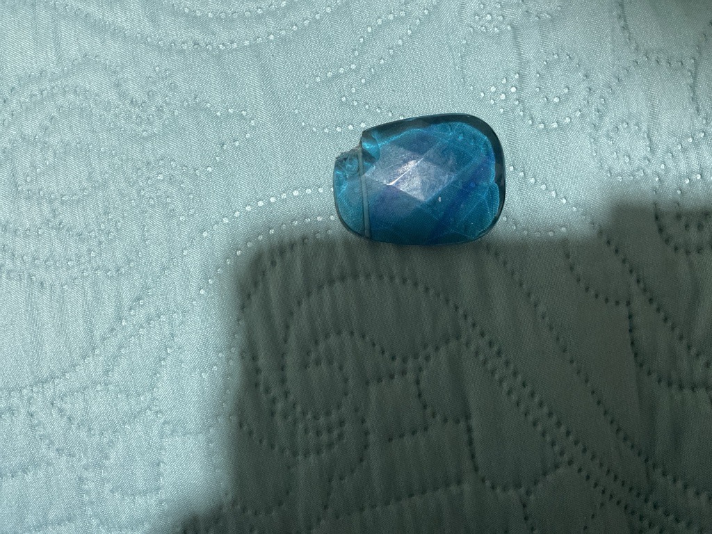 Not a diamond; this is a faceted blue glass or synthetic crystal piece with obvious internal fractures and surface wear. - Irregular Cushion / Freeform Cabochon with rose-cut facets