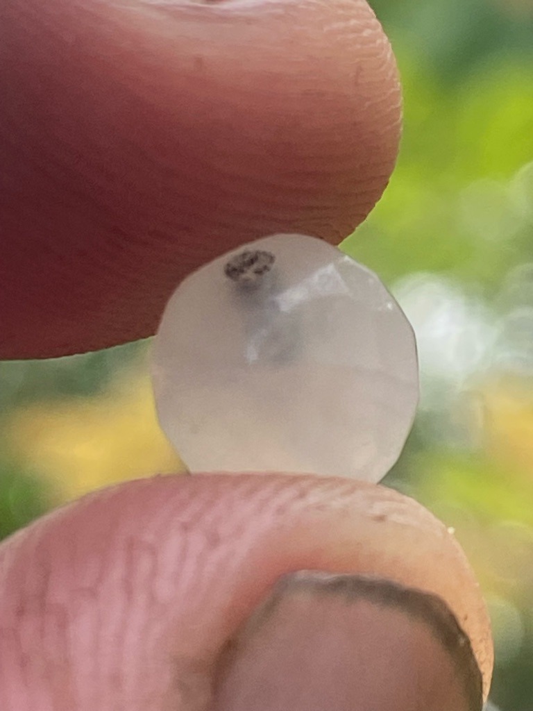 Natural rough or heavily included crystal, appearing more like a low-grade industrial diamond, quartz, or chalcedony due to extreme opaqueness and dark inclusions, but evaluated as a diamond raw specimen for analysis. - Irregular round / rounded rough crystal with primitive native facets or polishing attempts