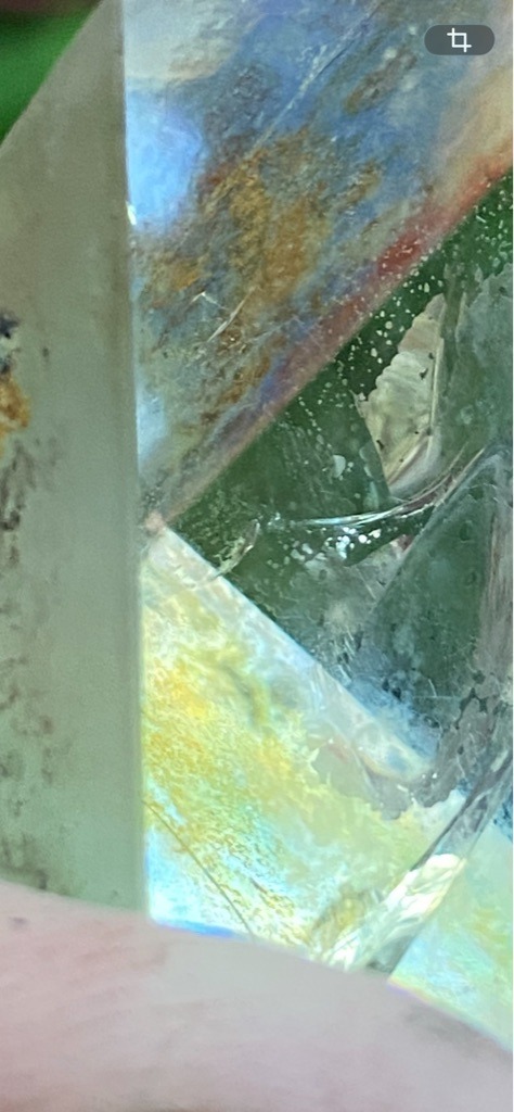 Not a diamond; appears to be coated or treated quartz, glass, or a similar crystal with surface iridescence (such as aura quartz). - Irregular / Raw or tumbled crystal fragment