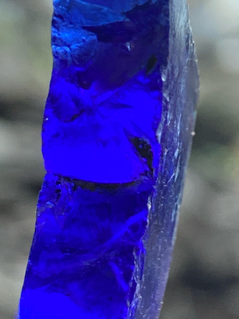 Not a diamond; this appears to be a piece of rough or cut colored glass or synthetic material, dyed or strongly lit with blue light, rather than carbon-based diamond. - Irregular raw slab or fragment, non-standard shape