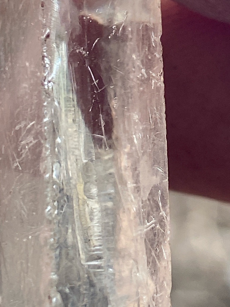 The image shows a raw, uncut mineral crystal matrix rather than a faceted diamond. Visually, it appears to be a quartz or beryl crystal with needle-like inclusions (resembling tourmaline or rutile), not a diamond. - Rough crystal / uncut mineral form (no standard diamond shape)