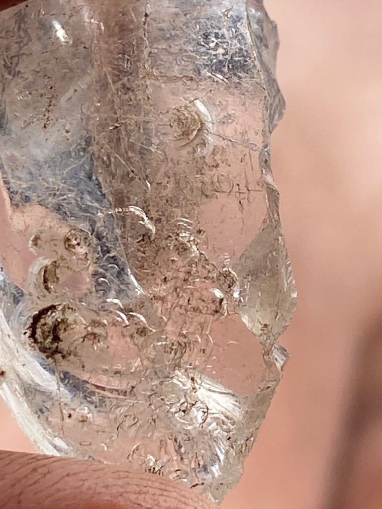 Not a diamond (likely quartz, glass, or industrial crystal based on the conchoidal fractures, internal gas bubbles, and amorphous structure visible) - Rough / Raw irregular fragment