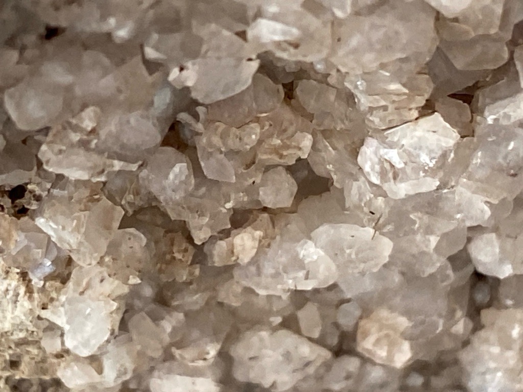 Not Applicable - The image shows a cluster of unpolished quartz crystals within a geode or mineral matrix, not gem-grade diamonds. - Rough crystal formations with natural crystal faces, not cut/faceted.