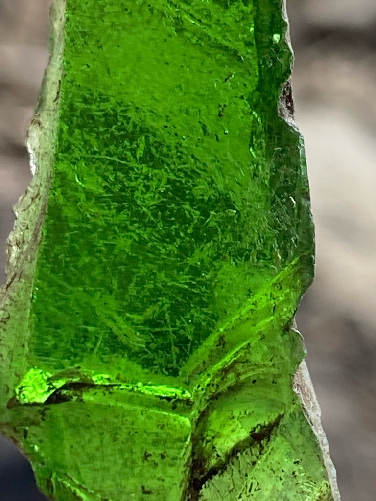 Not a diamond; this is a piece of green glass or slag, displaying characteristic conchoidal fracture patterns and internal bubbles typical of man-made glass. - Raw, unstructured shard / Irregular fragment