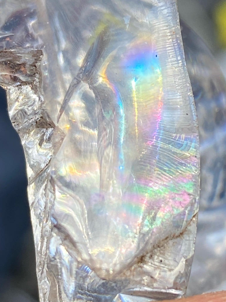 The specimen appears to be non-diamond, likely a variety of Quartz (Rock Crystal) or Glass/Slag based on the conchoidal fracture and lack of adamantine luster. - Rough / Uncut (Natural fragment)